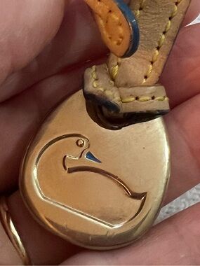 Vintage Dooney & Bourke bag charm fob brass duck logo on a leather strap